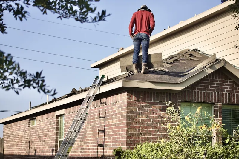 Professional roofer working on a residential roof in Atascadero